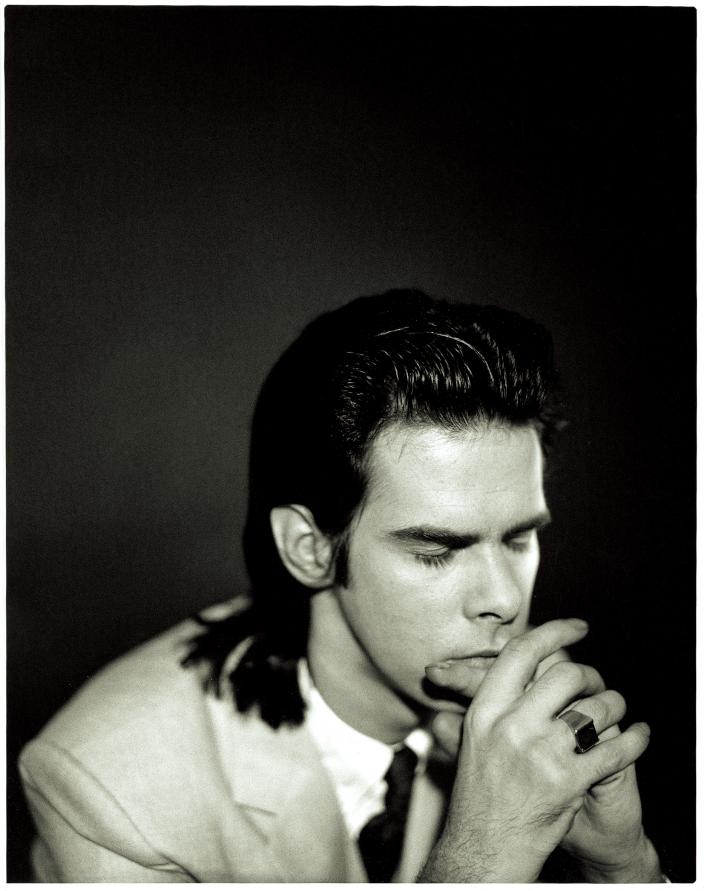 Nick Cave in a prayer pose.